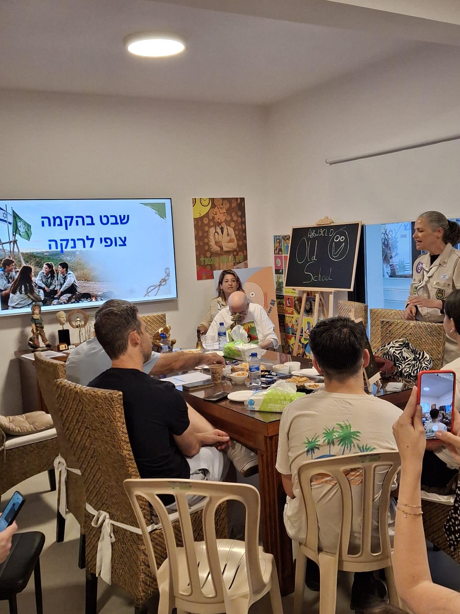 Wide view of the hub gathering with the founding slide on screen